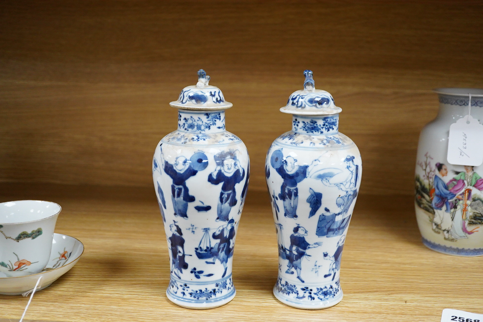 A pair of 19th century Chinese blue and white vases and covers. 22.5cm high